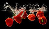 Vivid Red Peppers in Splashing Water